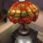 Stained glass antique lamp in lightly lit room